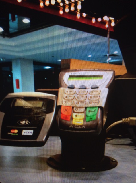 Shows non-portable card reader which glare from above lights.